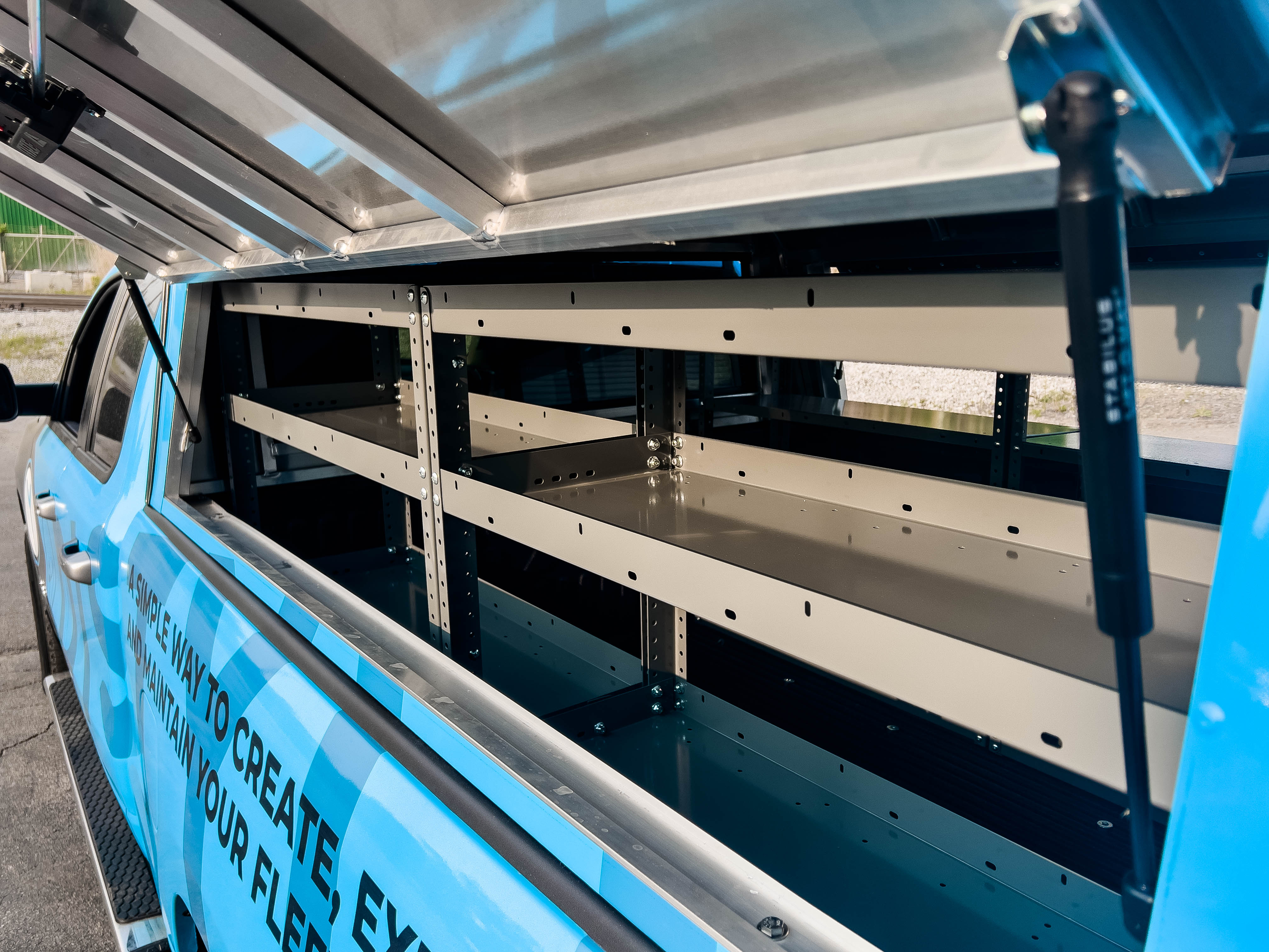 exterior view of two empty shelves in a pickup fully upfitted with an Adrian Steel Base truck storage package