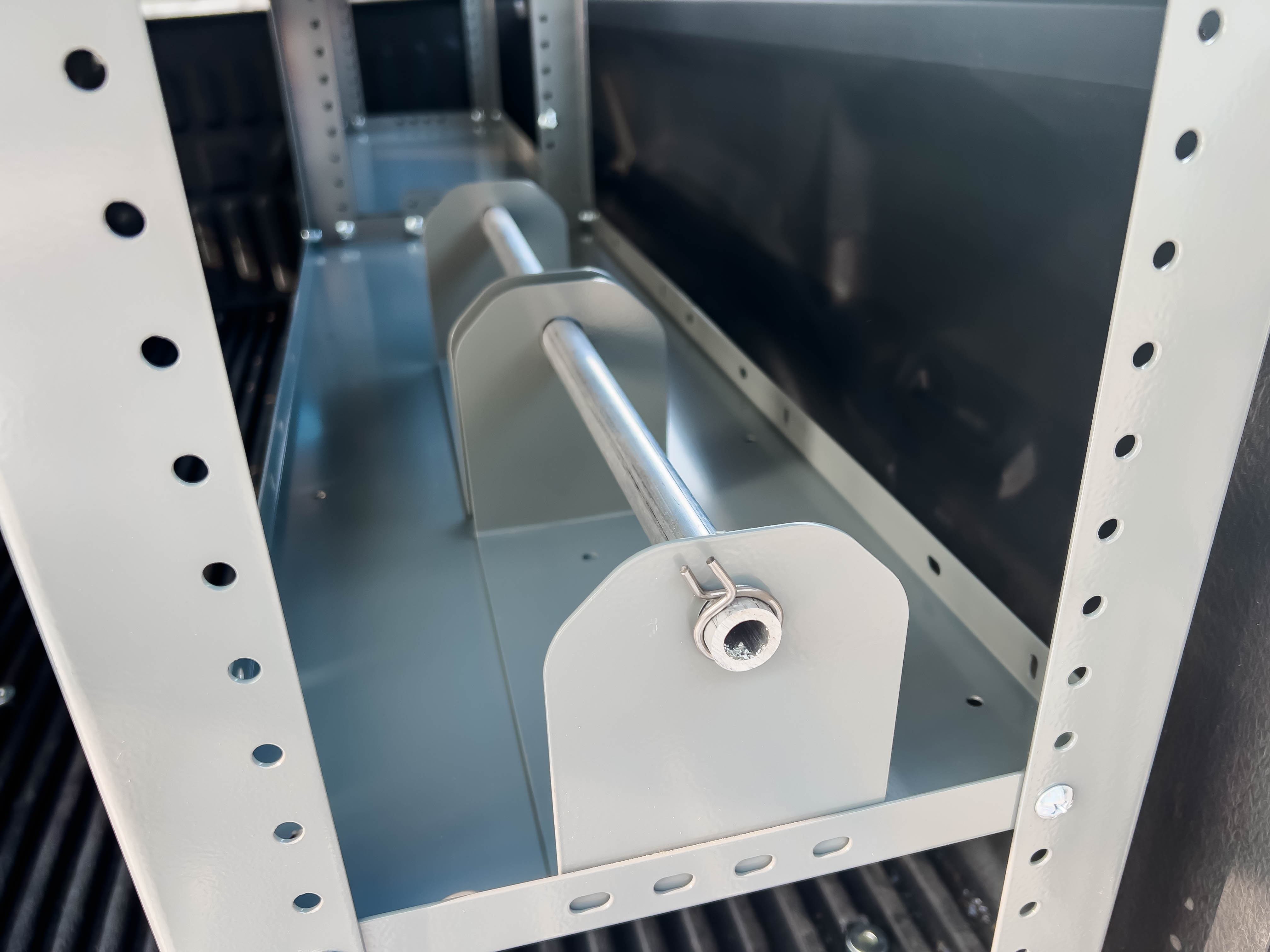 two single spool holders on a shelf in a pickup upfitted with an Adrian Steel Electrician storage package