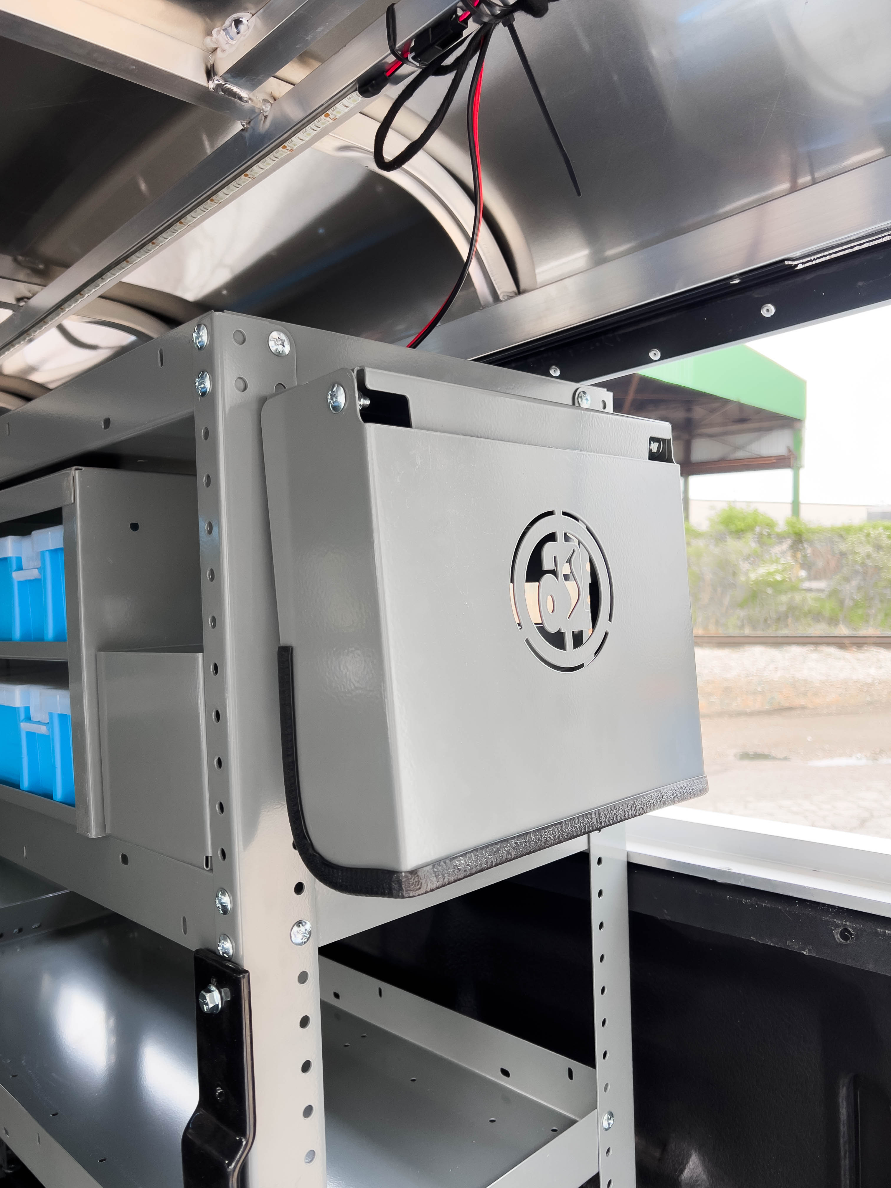 an HVAC gauge cover kit mounted on the rear panel of a shelf in a pickup upfitted with an Adrian Steel HVAC storage package