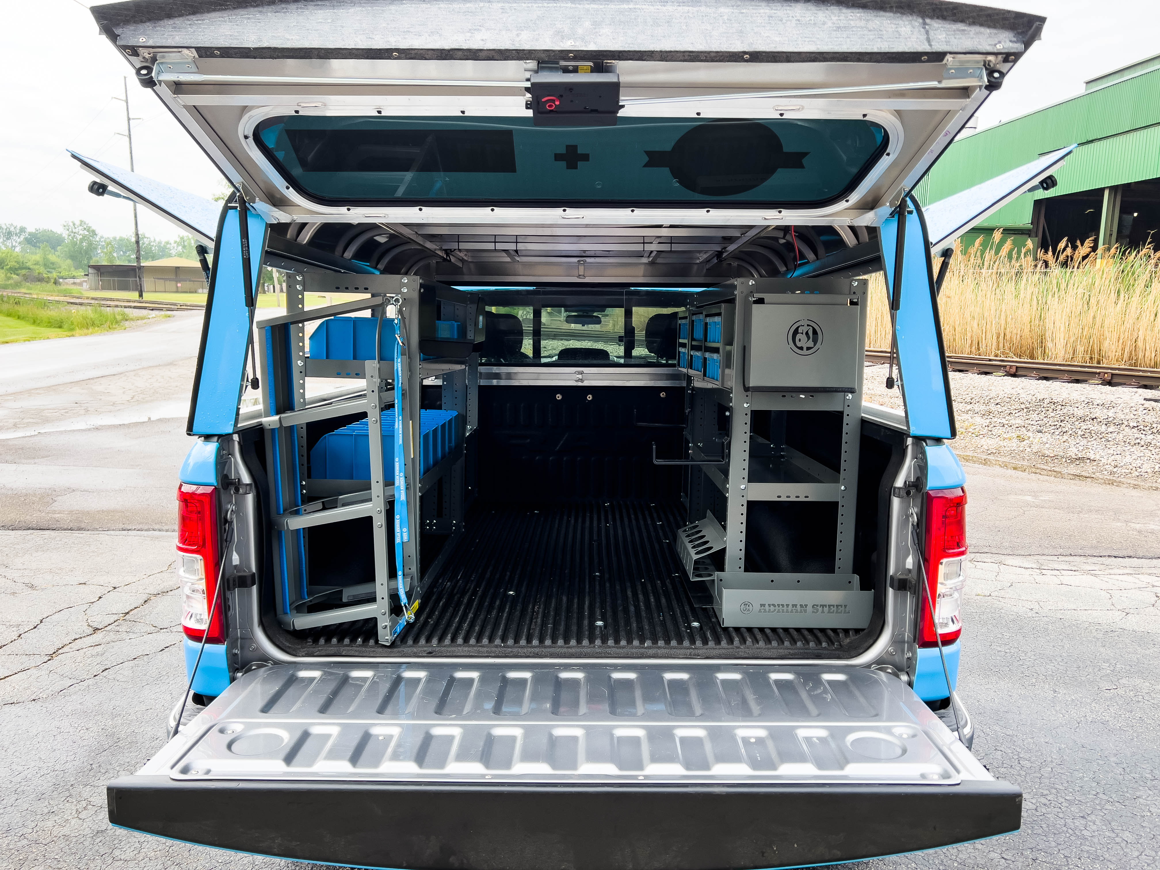 rear view of a pickup upfitted with an Adrian Steel HVAC/Mechanical truck storage package