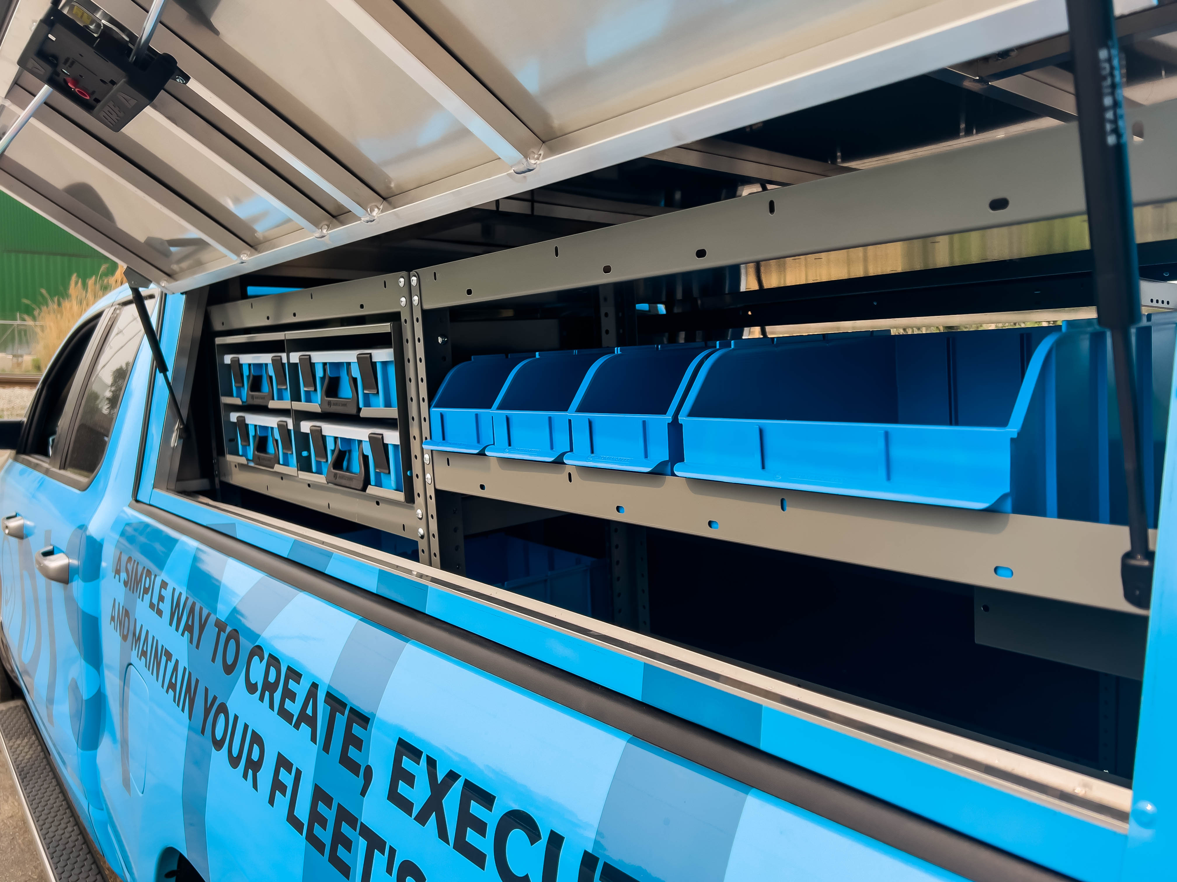 exterior of a shelf with bins and portable parts cases in a pickup upfitted with an Adrian Steel Security Contractor package