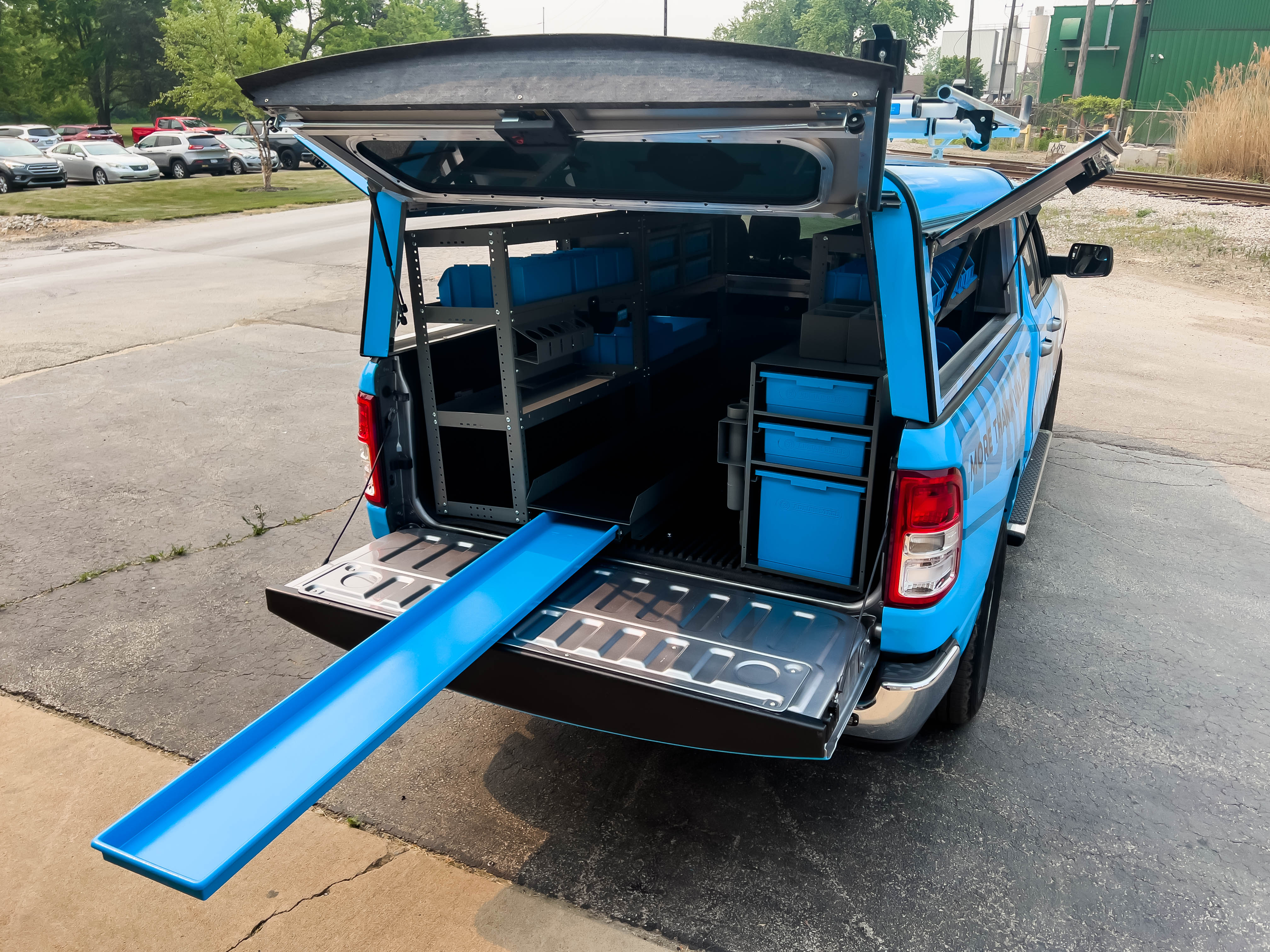 a ladder shelf/bit holder with its pull-out tray fully extended in a pickup upfitted with a Security Contractor package