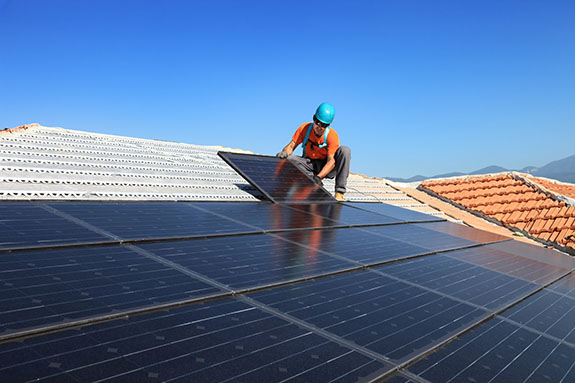 man installing photovoltaic solar panels | Renewable Energy Technician | Adrian Steel