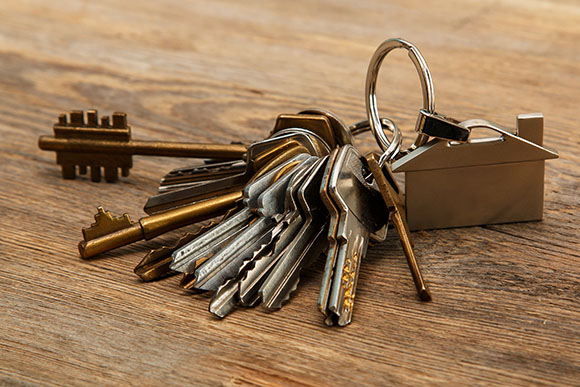 bunch of different keys on wooden surface | Adrian Steel locksmith package
