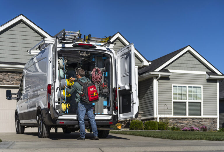 technician grabbing tools out of hvac upfit work van