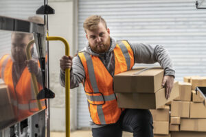 Parcel delivery worker stepping in a van upfitted for parcel delivery.