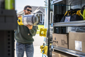 Worker getting supplies out of an upfitted van.