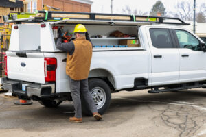 Worker getting tools out of their work truck